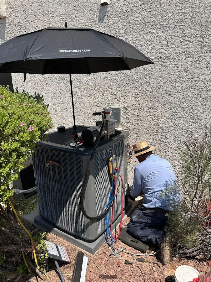 HVAC technician performing outdoor AC maintenance in Sweetwater